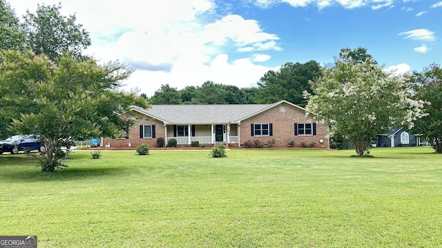 single story home with a front yard, covered porch, and brick siding