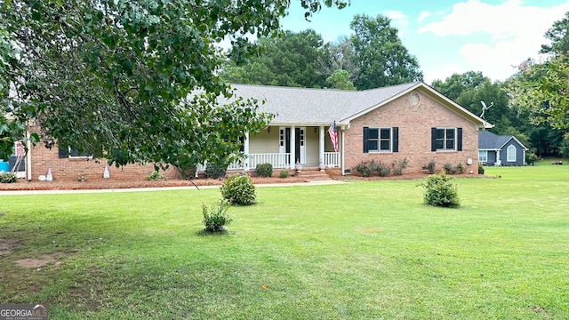 ranch-style home with covered porch and a front yard