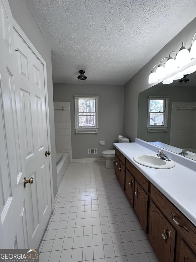 full bath with visible vents, toilet, a textured ceiling, vanity, and tile patterned floors