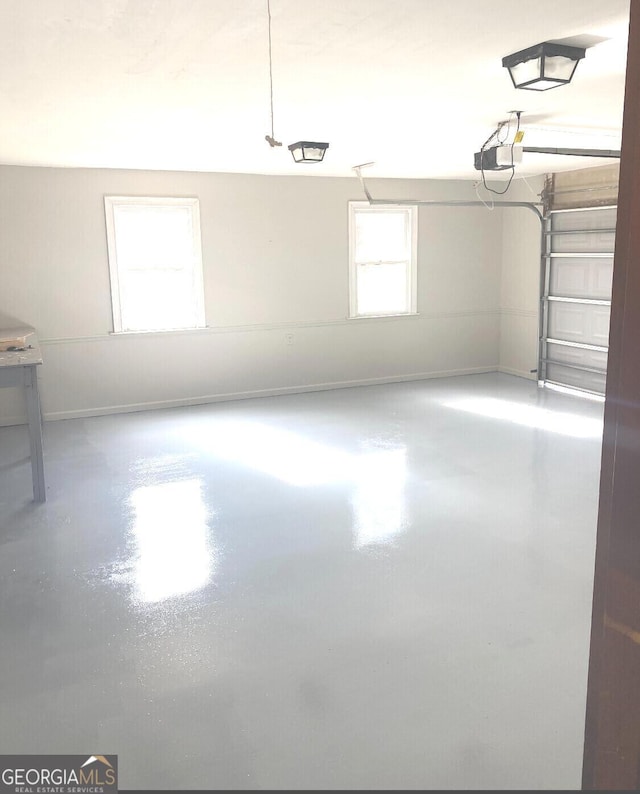 garage featuring baseboards and a garage door opener