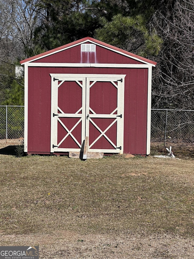 view of shed with fence