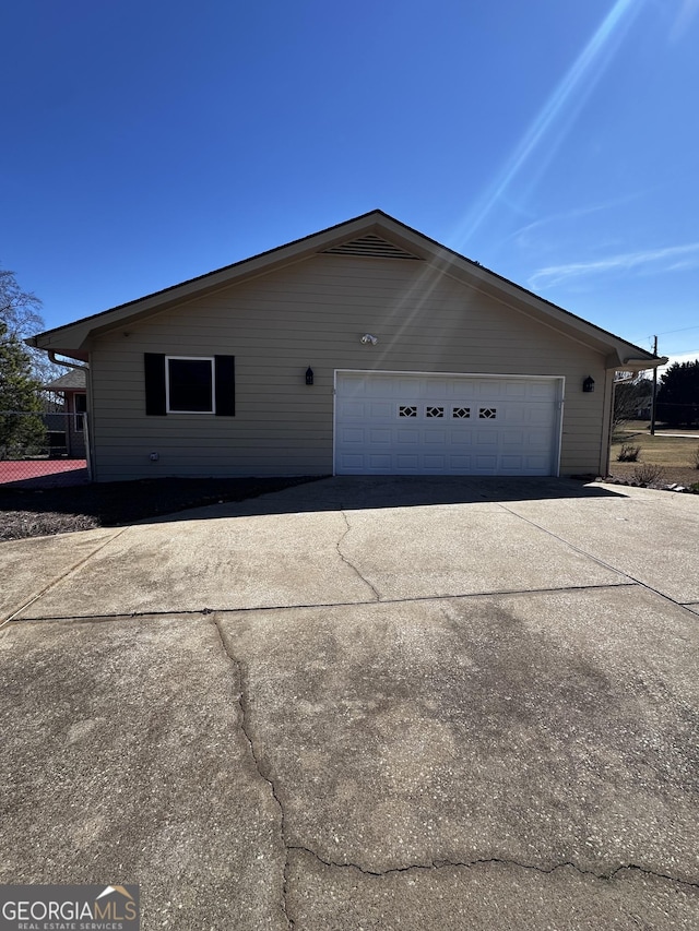 view of side of home featuring a garage