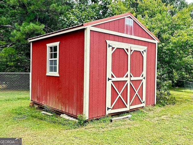 view of outbuilding with a yard