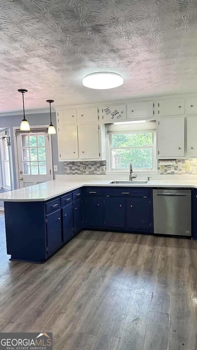 kitchen featuring a sink, blue cabinetry, stainless steel dishwasher, and a peninsula