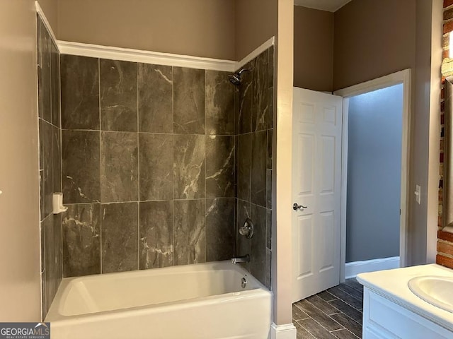 bathroom with tiled shower / bath combo and vanity