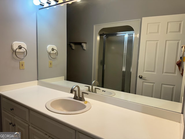 bathroom featuring vanity and a shower with shower door