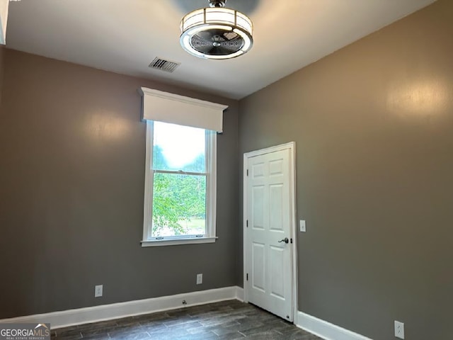 unfurnished room featuring dark hardwood / wood-style floors