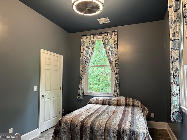 bedroom featuring multiple windows and light wood-type flooring