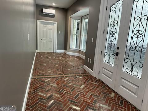 doorway to outside with an AC wall unit