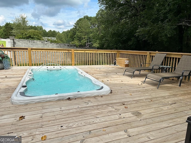 view of swimming pool featuring a deck