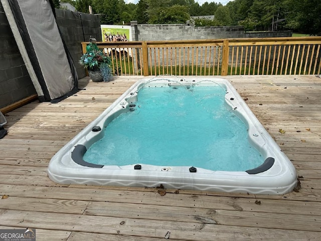 view of swimming pool featuring a wooden deck