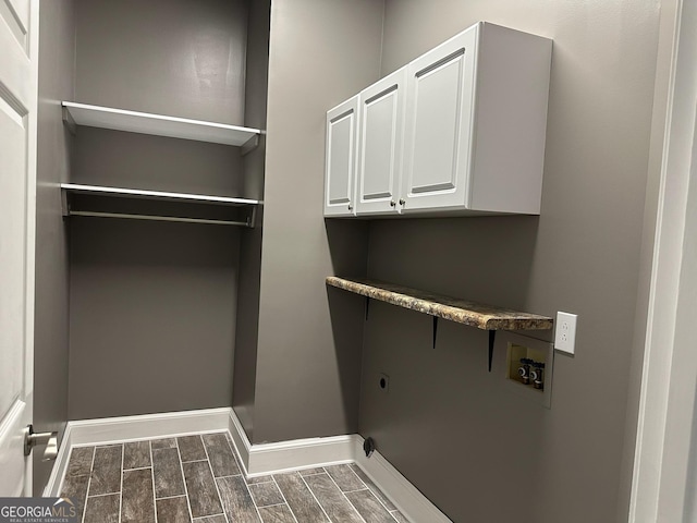 clothes washing area with cabinets, hookup for a washing machine, and electric dryer hookup