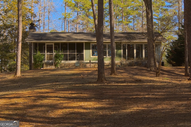 view of front of home featuring a sunroom