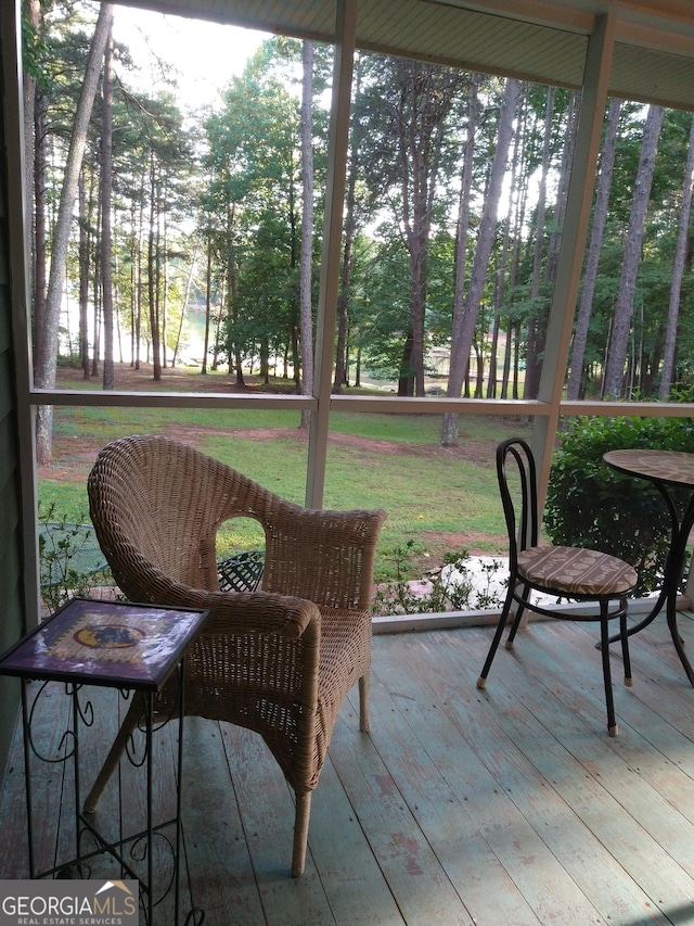 sunroom / solarium featuring a healthy amount of sunlight