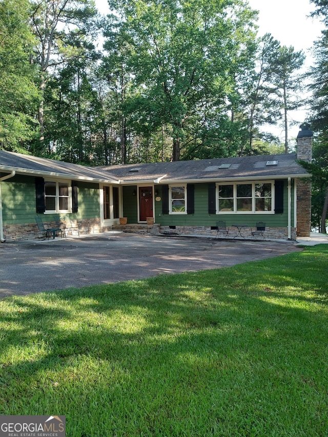 ranch-style home featuring a patio and a front yard