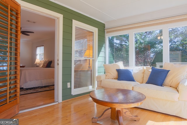 sunroom / solarium with a ceiling fan and visible vents