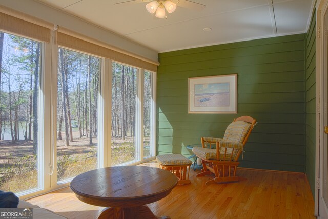 kitchen with crown molding, a kitchen bar, butcher block countertops, decorative backsplash, and hardwood / wood-style flooring