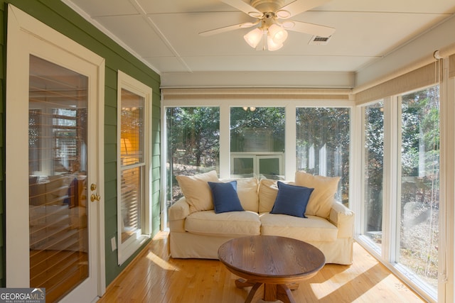 sunroom with ceiling fan and visible vents