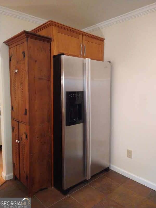 kitchen featuring crown molding and stainless steel fridge