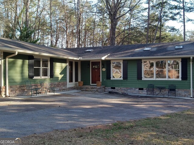 rear view of house with a sunroom and a yard