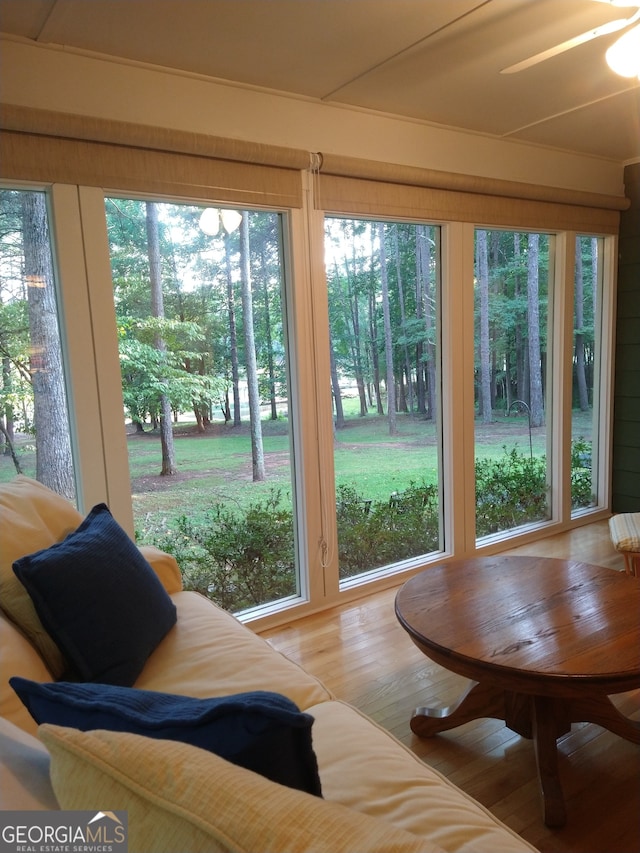 sunroom / solarium with a wealth of natural light and ceiling fan