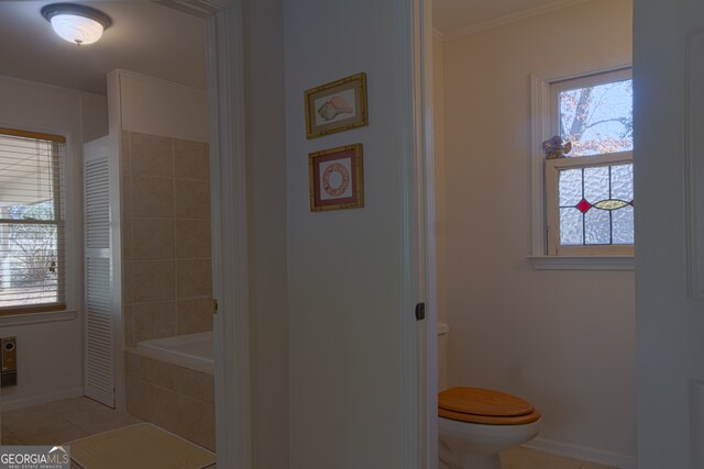 bathroom featuring tile walls, toilet, an enclosed shower, and tile patterned floors