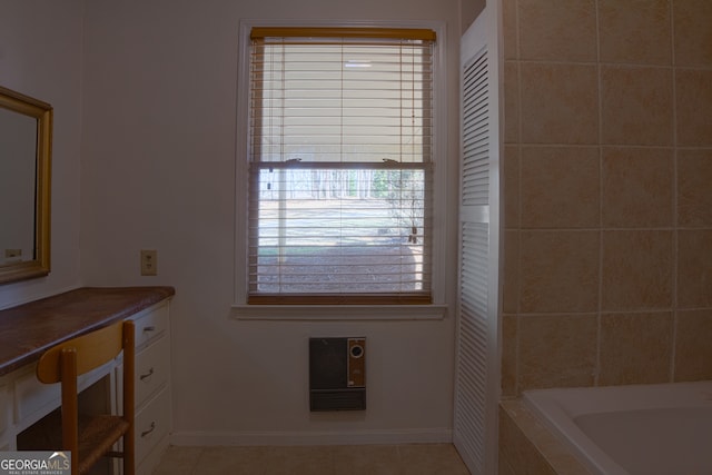 full bathroom featuring tiled tub, tile patterned flooring, and baseboards