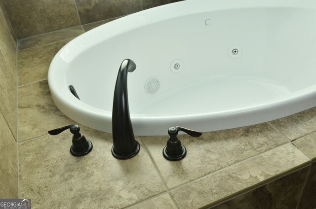 details with a bathing tub and tile patterned floors