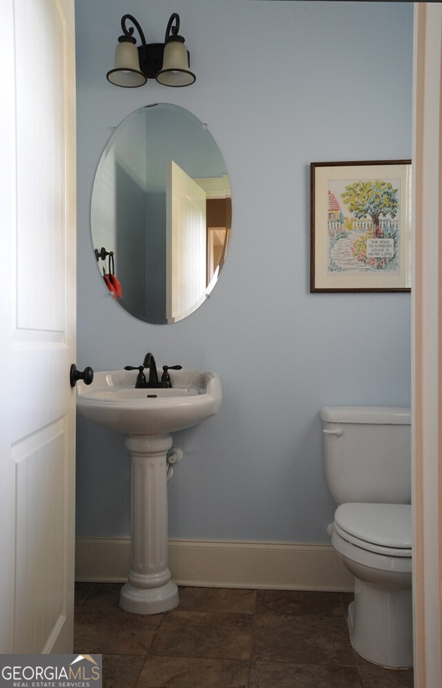 bathroom with toilet and tile patterned flooring