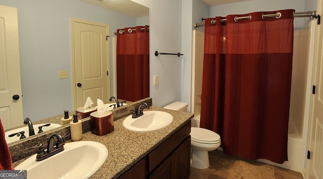 bathroom featuring tile patterned floors, dual bowl vanity, and toilet