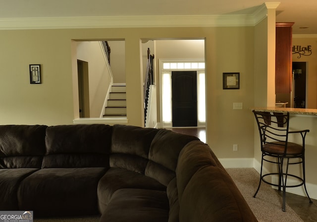 carpeted living room with ornamental molding