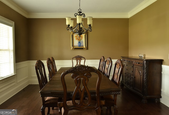 dining area with dark hardwood / wood-style floors, a chandelier, and ornamental molding