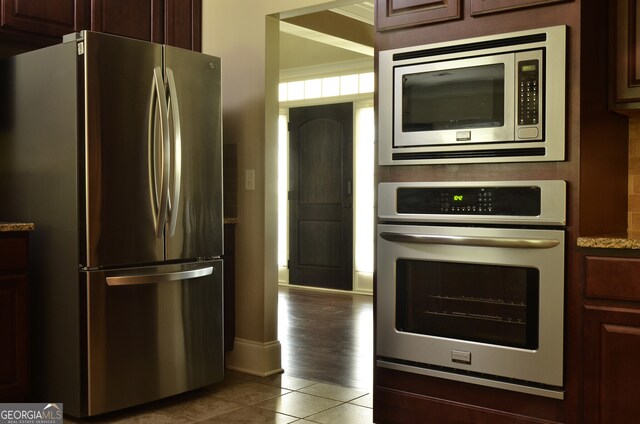 kitchen featuring stainless steel appliances and tile patterned floors