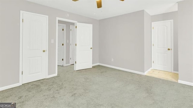 unfurnished bedroom featuring ceiling fan and light carpet