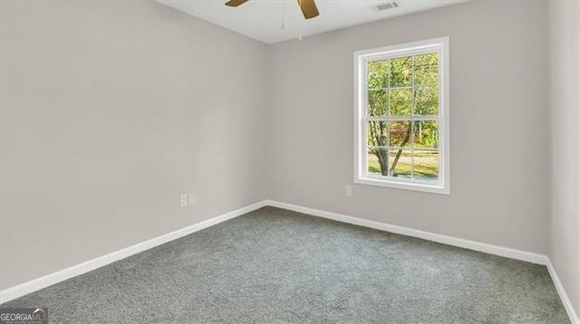 carpeted empty room featuring ceiling fan and a healthy amount of sunlight