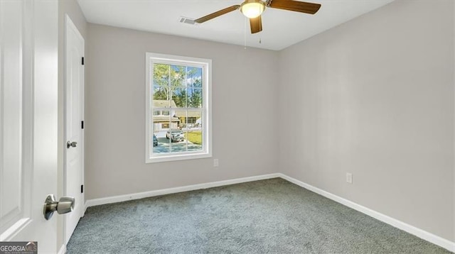 carpeted spare room with ceiling fan