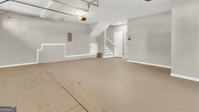 garage featuring electric panel and a garage door opener