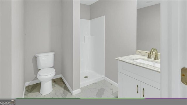 bathroom featuring vanity, toilet, and walk in shower