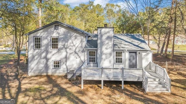 rear view of property featuring a deck and central AC unit