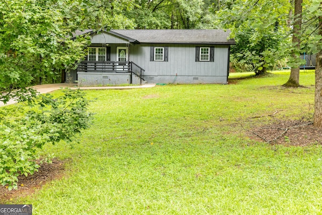 view of front facade with crawl space, a shingled roof, a porch, and a front lawn