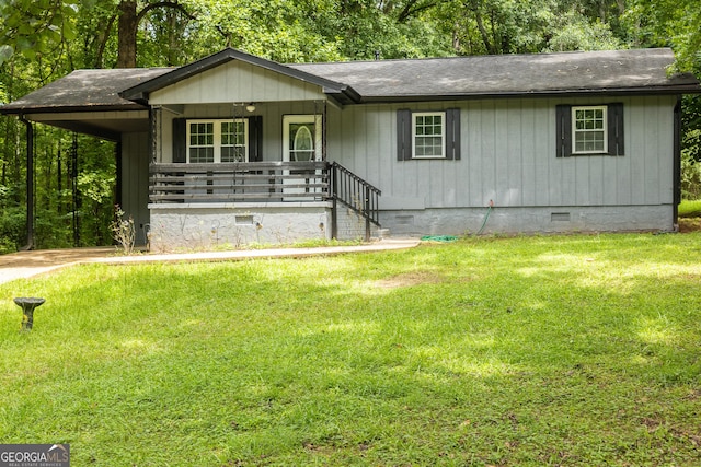 single story home featuring crawl space, a porch, an attached carport, and a front yard