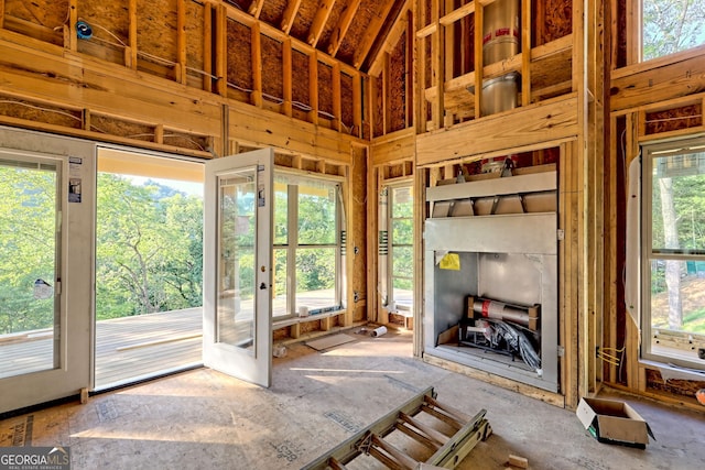 unfurnished living room with a high ceiling and french doors