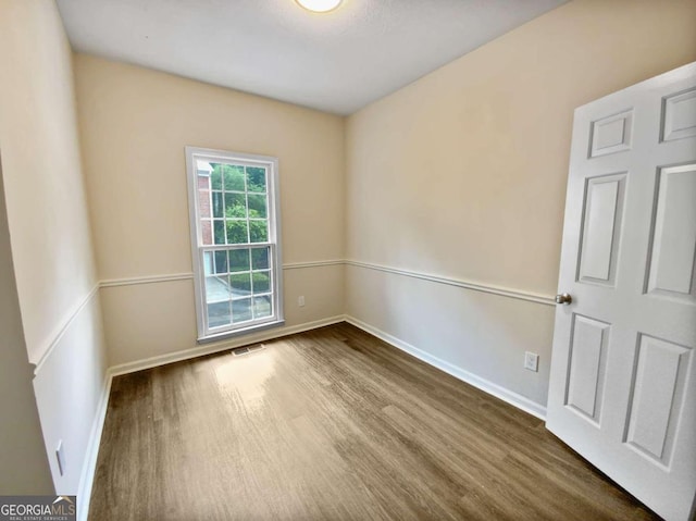 unfurnished room with hardwood / wood-style floors