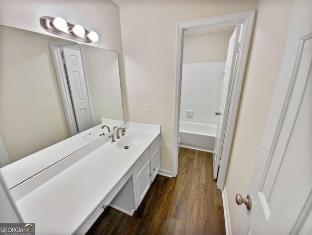 full bathroom featuring vanity, toilet,  shower combination, and hardwood / wood-style floors