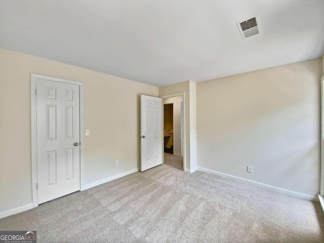 empty room featuring light carpet