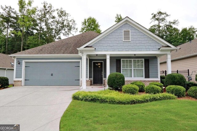 view of front of house with a garage and a front lawn