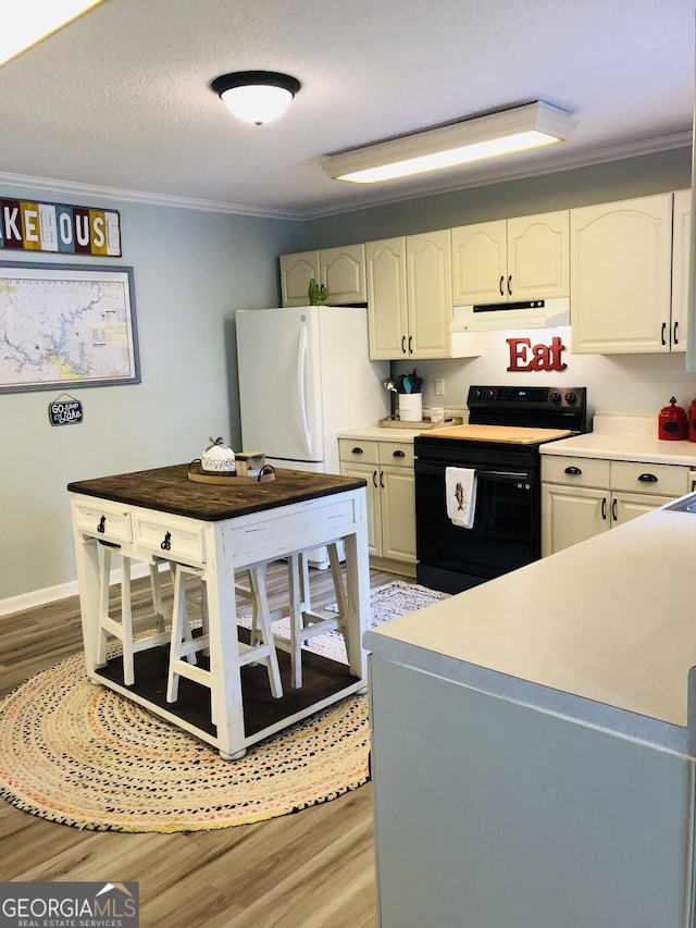 kitchen featuring white refrigerator, ornamental molding, a textured ceiling, white cabinets, and black range with electric cooktop