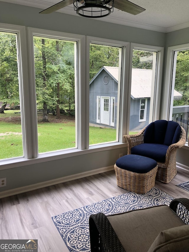 sunroom / solarium featuring ceiling fan