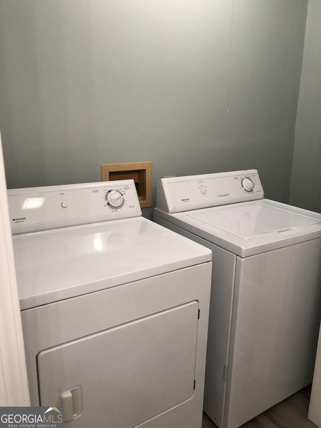 washroom featuring washing machine and dryer and hardwood / wood-style floors