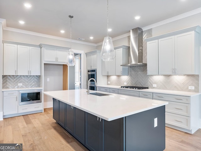 216 Ewing Way, Dacula, GA 30019 - kitchen featuring wall chimney range hood, appliances with stainless steel finishes, crown molding, a large island, and backsplash
